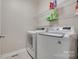 The laundry room has white washer and dryer sets, wire shelving, and tiled flooring at 1342 Crown Ridge Dr # 38, Fort Mill, SC 29708