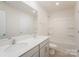 Well-lit bathroom with double sink vanity and combined shower/tub unit at 138 Maritime St, Mooresville, NC 28117
