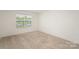 Bedroom with neutral carpeting and a bright window overlooking the neighborhood at 138 Maritime St, Mooresville, NC 28117