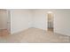 Bedroom showcasing closet, bathroom access, neutral carpet, and a soothing atmosphere at 138 Maritime St, Mooresville, NC 28117