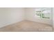 Neutral bedroom with window offering neighborhood view and ample natural light at 138 Maritime St, Mooresville, NC 28117