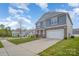 Beautiful two-story home with a stone facade, a long driveway, and a well-manicured front lawn at 138 Maritime St, Mooresville, NC 28117