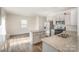 Well-lit kitchen featuring granite countertops, stainless steel appliances, and hardwood floors at 138 Maritime St, Mooresville, NC 28117