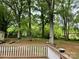 Backyard view from the wooden deck with large trees at 1400 Lackey St, Shelby, NC 28152