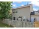 View of home's backyard and siding with a partial view of the wooden fence at 15009 Medlock Ln, Charlotte, NC 28277
