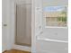 Bright bathroom featuring a large bathtub, a walk in shower with glass door, and a window at 15009 Medlock Ln, Charlotte, NC 28277