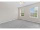Bedroom featuring two windows, neutral paint, and carpeted floors at 15009 Medlock Ln, Charlotte, NC 28277