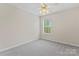 Bedroom featuring a ceiling fan, neutral paint, carpeted floors and a window with blinds at 15009 Medlock Ln, Charlotte, NC 28277