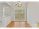 Bright dining area featuring wood floors, a sliding glass door, and stylish light fixture at 15009 Medlock Ln, Charlotte, NC 28277