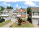 Lovely two-story house with a brick accent, attached garage, and landscaped front yard at 15009 Medlock Ln, Charlotte, NC 28277