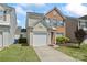 Charming two-story home featuring a brick facade, attached garage and well-manicured lawn at 15009 Medlock Ln, Charlotte, NC 28277