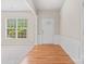 Welcoming foyer with hardwood floors, decorative molding, and natural light from a large window at 15009 Medlock Ln, Charlotte, NC 28277