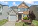 Charming two-story home with brick and vinyl siding, attached garage, and manicured lawn at 15009 Medlock Ln, Charlotte, NC 28277
