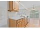 Kitchen featuring white countertops, wooden cabinets, and view to the breakfast area at 15009 Medlock Ln, Charlotte, NC 28277