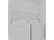 Laundry room featuring a white washer and dryer with overhead shelving at 15009 Medlock Ln, Charlotte, NC 28277