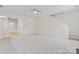 Spacious living room with neutral carpet, ceiling fan, and staircase at 15009 Medlock Ln, Charlotte, NC 28277