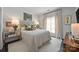 Cozy bedroom with white comforter, painting on the wall, and black hardwood floors at 1550 High St, Charlotte, NC 28211