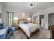 This bedroom showcases a comfortable bed, modern lighting, and an en-suite bathroom, providing a cozy retreat at 1550 High St, Charlotte, NC 28211