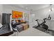 This spacious bonus room features a modern piano, Peloton bike, and comfortable lounge area at 1550 High St, Charlotte, NC 28211