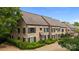 An elevated view of a stone townhome showcasing its architectural details and landscaped surroundings at 1550 High St, Charlotte, NC 28211