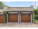 Charming stone garage with three wood doors and brick driveway at 1550 High St, Charlotte, NC 28211