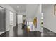 Well-lit hallway featuring wood floors and access to multiple rooms on both sides at 1550 High St, Charlotte, NC 28211