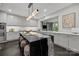 A sleek, modern kitchen with a large island, seating, and contemporary finishes with pendant lighting at 1550 High St, Charlotte, NC 28211