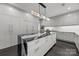 A modern kitchen featuring sleek gray cabinetry, a marble island, and stainless steel appliances at 1550 High St, Charlotte, NC 28211