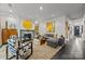 Well-lit living room boasts a marble fireplace, eclectic art, and comfortable seating, creating a welcoming space at 1550 High St, Charlotte, NC 28211