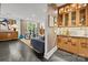 Open living room with hardwood floors, built-in bar area, and access to an outdoor area with French doors at 1550 High St, Charlotte, NC 28211