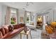 Bright and inviting living room with a plush sofa, decorative pillows, and large windows overlooking greenery at 1550 High St, Charlotte, NC 28211