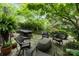 Stone patio with seating and mature landscaping creates a serene outdoor living space at 1550 High St, Charlotte, NC 28211