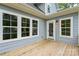 Wooden back porch of this house with a white door, windows, and light at 156 Clear Springs Rd, Mooresville, NC 28115