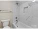Bright bathroom with modern fixtures, bathtub and shower, and marble tiling at 156 Clear Springs Rd, Mooresville, NC 28115