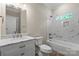 Well-lit bathroom with marble countertop, modern fixtures, white cabinetry, and shower-tub combo at 156 Clear Springs Rd, Mooresville, NC 28115