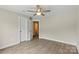 Bright bedroom with hardwood floors, ceiling fan and open door to ensuite bathroom at 156 Clear Springs Rd, Mooresville, NC 28115