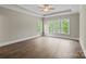 Main bedroom features wood floors, tray ceiling, ceiling fan, and multiple bright windows at 156 Clear Springs Rd, Mooresville, NC 28115