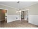 Dining room featuring chair rail molding, modern lighting, and hardwood floors with views into other rooms at 156 Clear Springs Rd, Mooresville, NC 28115