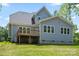 Back exterior view of a gray house with a deck and green lawn at 156 Clear Springs Rd, Mooresville, NC 28115