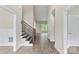 Bright foyer featuring hardwood floors, a staircase with wrought iron railings, and a high ceiling with white trim at 156 Clear Springs Rd, Mooresville, NC 28115