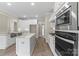 New kitchen with stainless appliances, white cabinetry, stone countertops and center island at 156 Clear Springs Rd, Mooresville, NC 28115