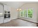 Eat in kitchen features stainless appliances, white cabinets, and large windows with a backyard view at 156 Clear Springs Rd, Mooresville, NC 28115