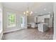 Eat in kitchen features stainless appliances, white cabinets, center island and access to outdoor deck at 156 Clear Springs Rd, Mooresville, NC 28115