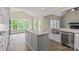 New kitchen with stainless appliances, white cabinetry, stone countertops, center island, and eat-in area at 156 Clear Springs Rd, Mooresville, NC 28115