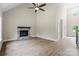 Bright living room with stone fireplace, wood floors, and vaulted ceiling with ceiling fan at 156 Clear Springs Rd, Mooresville, NC 28115