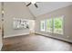 Bright living room with wood floors, a view to the kitchen, and three large windows at 156 Clear Springs Rd, Mooresville, NC 28115
