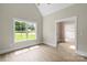 Bright neutral colored room featuring hardwood floors with a large window and entry to another room at 156 Clear Springs Rd, Mooresville, NC 28115