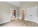 Neutral colored room featuring hardwood floors with views into other rooms and a double door closet at 156 Clear Springs Rd, Mooresville, NC 28115