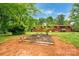 Landscaped backyard featuring a garden and a spacious grassy area at 1713 Wildwood Dr, Albemarle, NC 28001