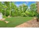 Expansive landscaped backyard featuring a garden and a grassy area at 1713 Wildwood Dr, Albemarle, NC 28001